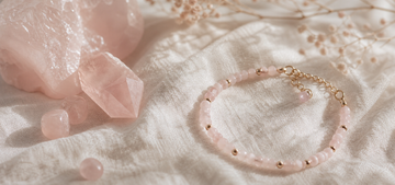 Rose quartz beads and soft pink crystal still life