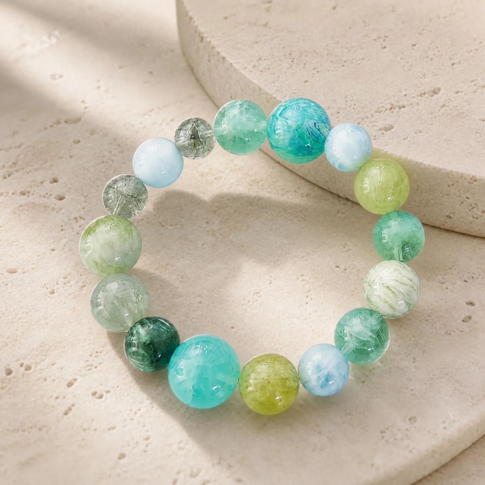 Multi-Gemstone Green Tones Bracelet - on minimalist stone surface