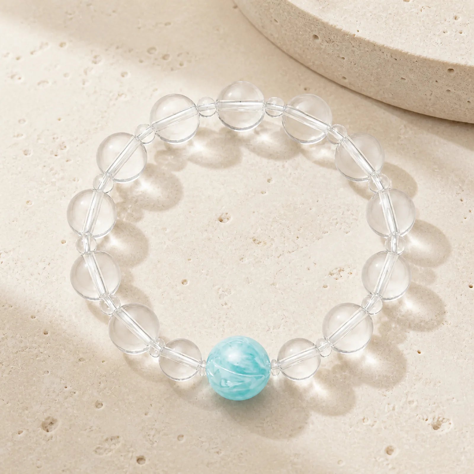 Clear Quartz & Blue Sapphire Bracelet - on minimalist stone surface